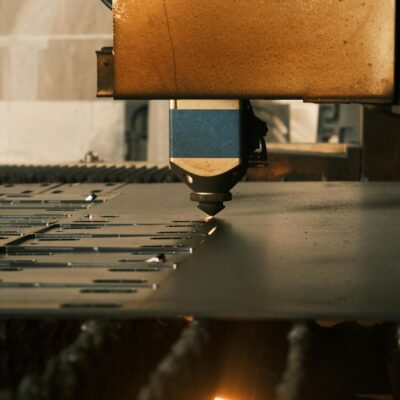 Photo by Cemrecan Yurtman A modern laser cutter in action at an industrial facility, showcasing precision machinery.