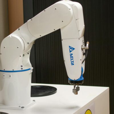 Close-up of a Delta brand robotic arm in an industrial setting, showcasing automation technology.